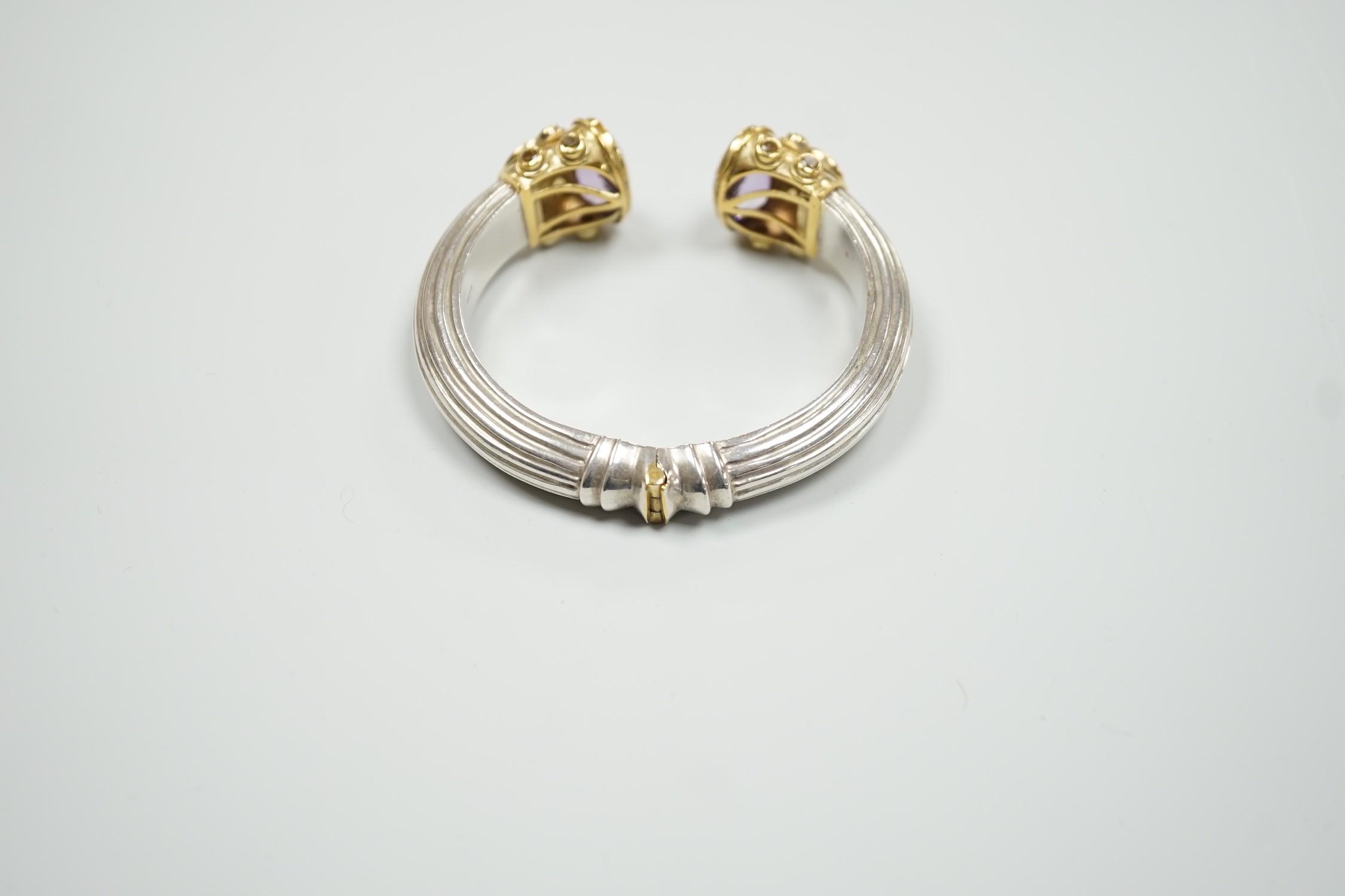 A modern parcel gilt silver amethyst and citrine set openwork spring hinged bangle.